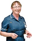 A nurse standing in uniform.
