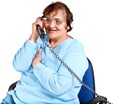 Person using a telephone and smiling.